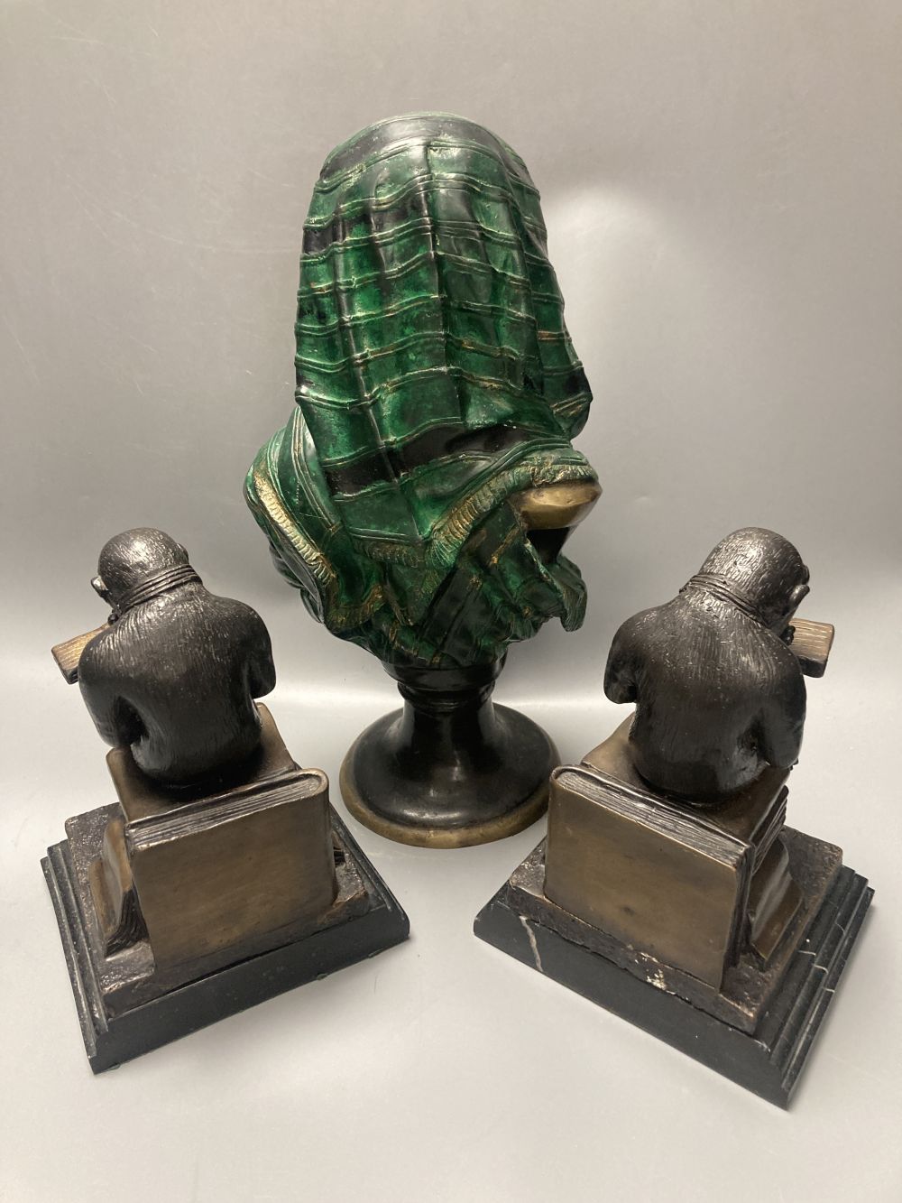 A pair of bronze monkey bookends and a cold painted bronze bust of a Nubian lady, height 32cm